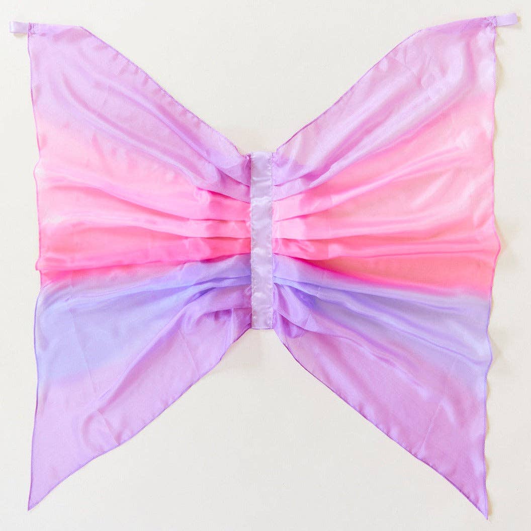 Gradient pink to purple bow-shaped fabric on a light background