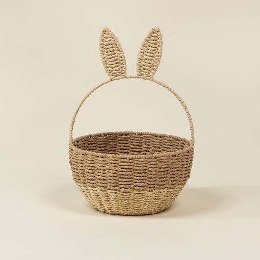 Woven basket with bunny ears on a beige background