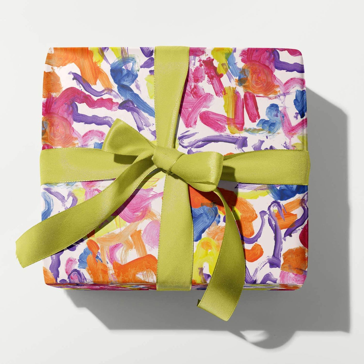 Colorful gift box with a green ribbon on a white background