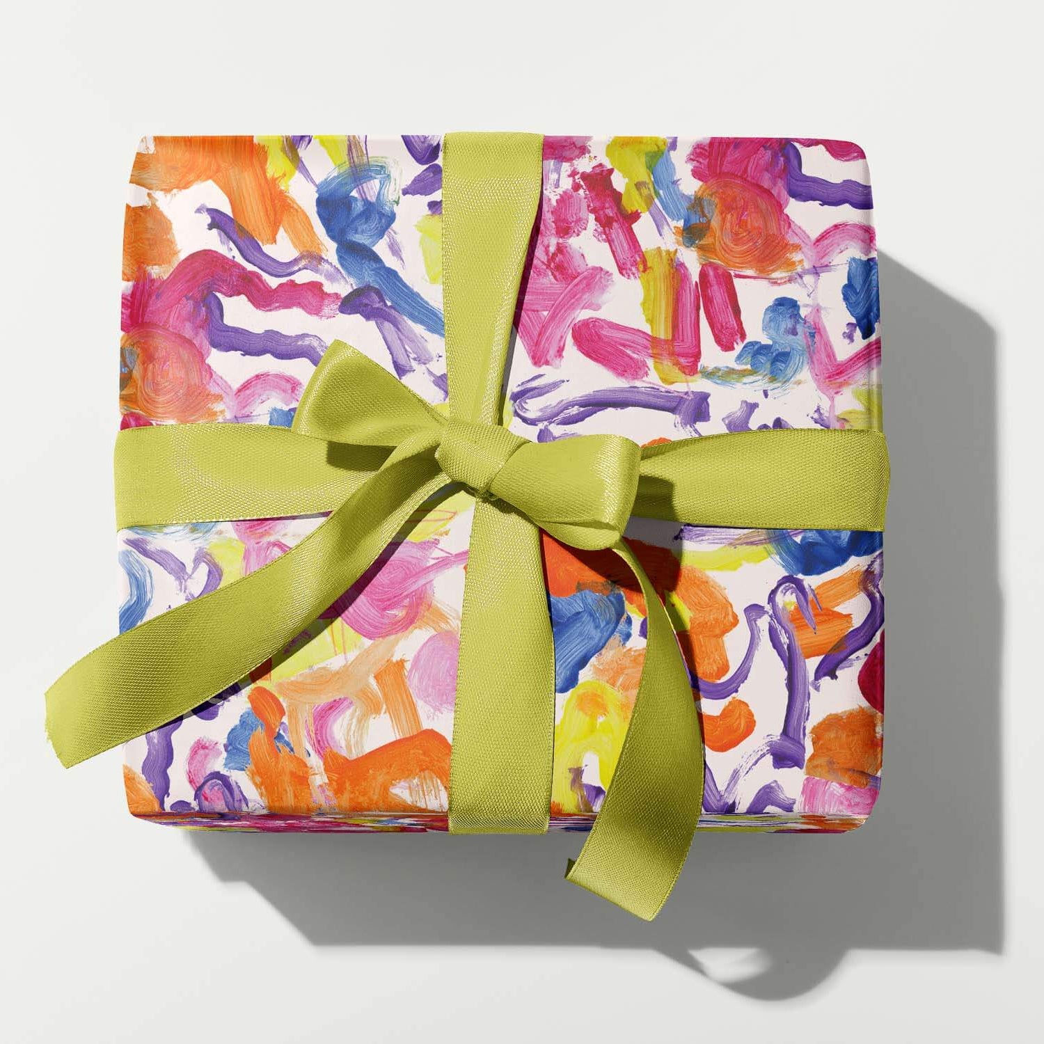 Colorful gift box with a green ribbon on a white background