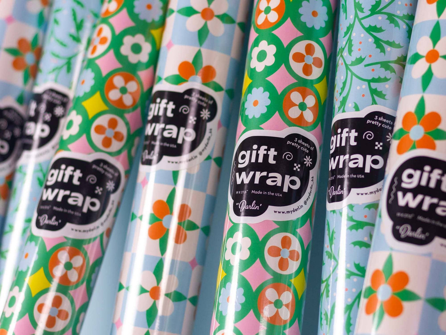 Rolls of floral gift wrap with 'gift wrap' label