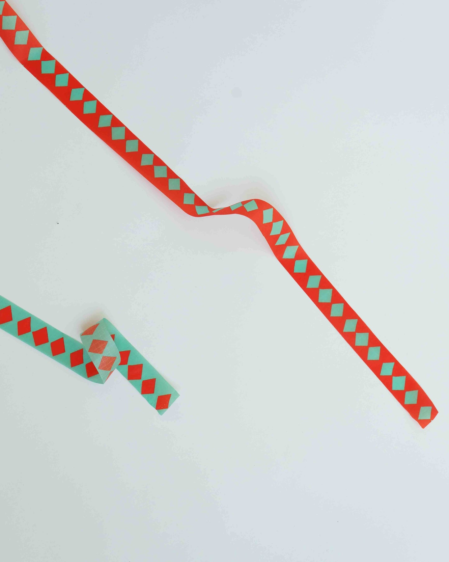 Red and green checkered ribbon on a white background