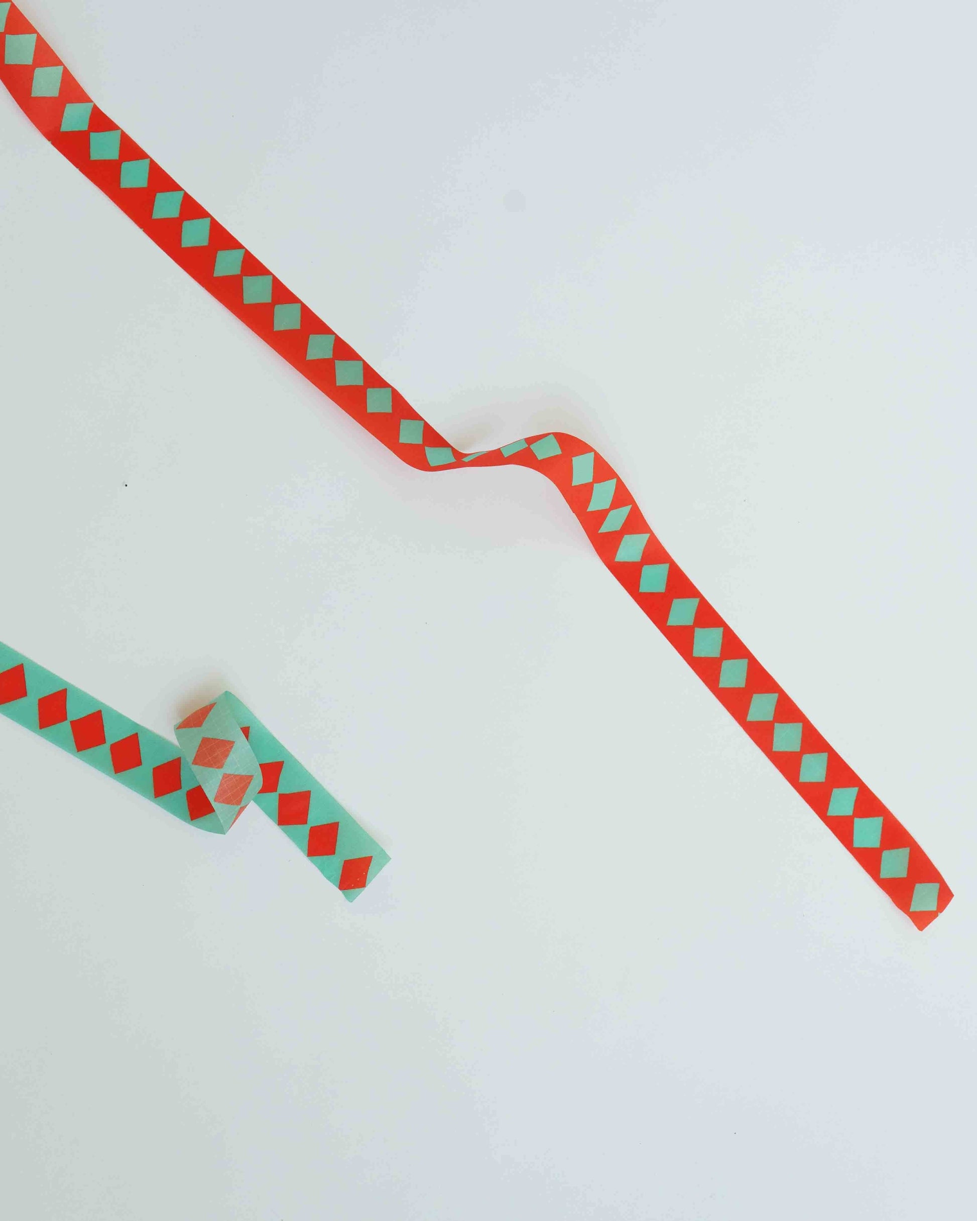 Red and green checkered ribbon on a white background