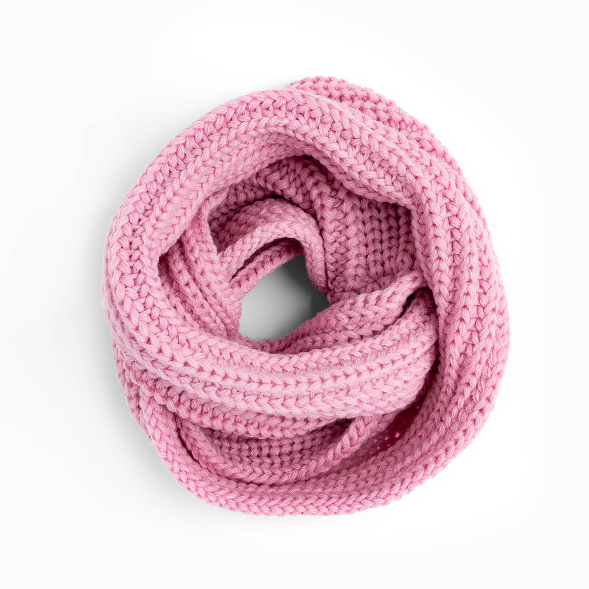 A chunky knit infinity scarf in a soft pink color, arranged in a loop on a clean white background.