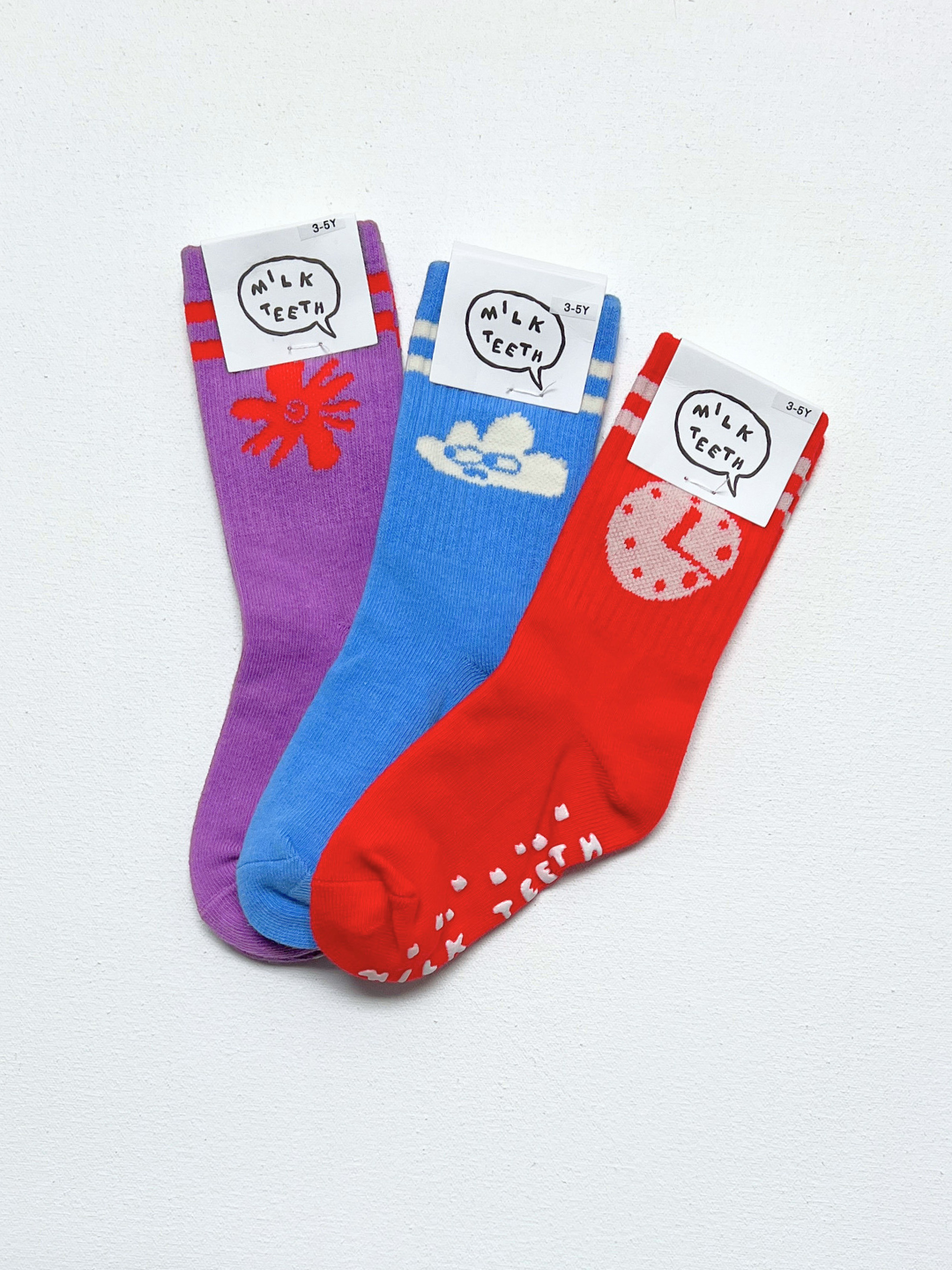 Three colorful socks with cartoon designs and labels on a white background