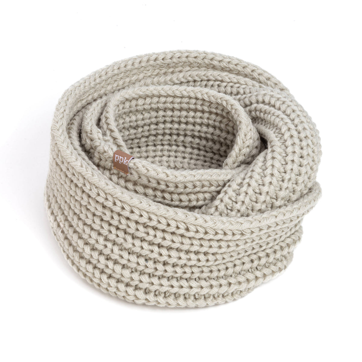 Knitted beige scarf on a white background