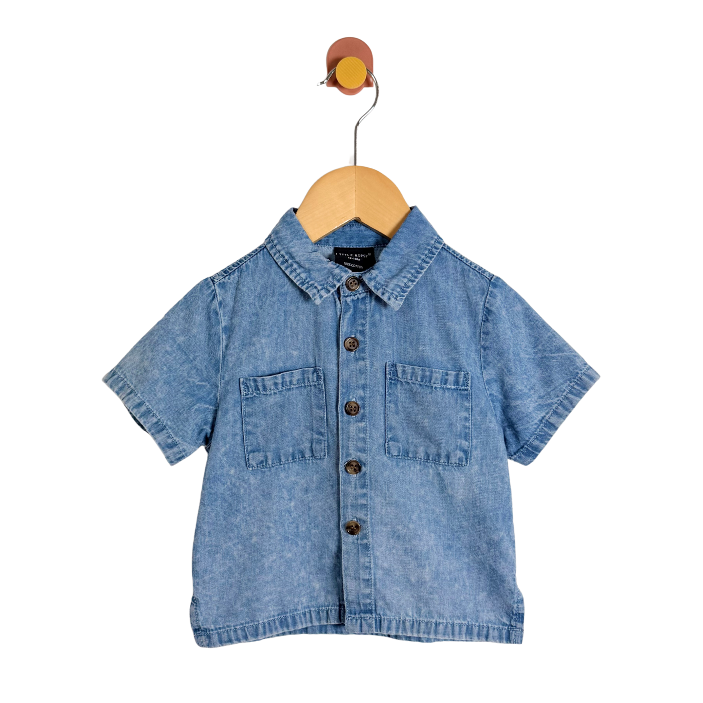 Blue denim shirt on a wooden hanger against a white background