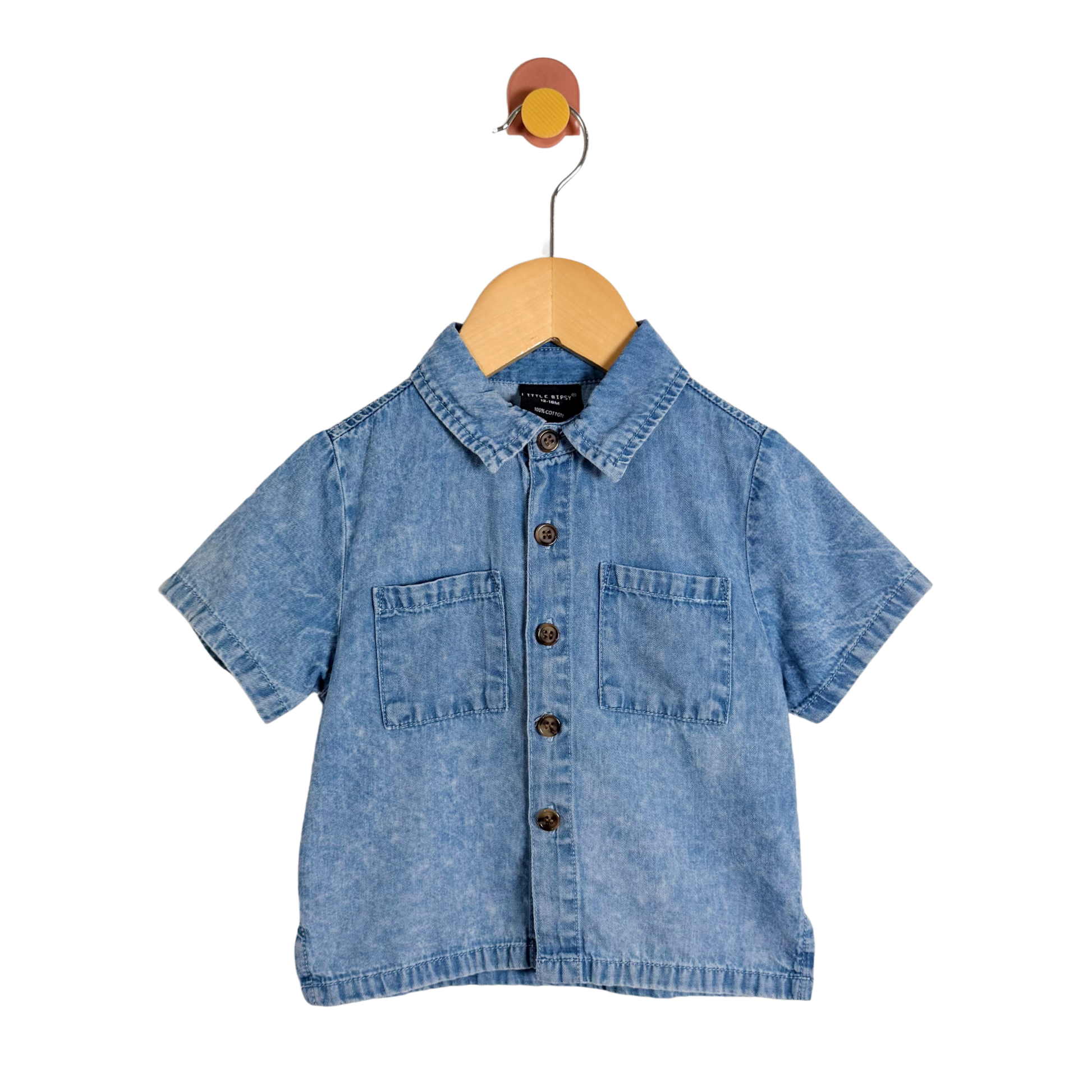 Blue denim shirt on a wooden hanger against a white background