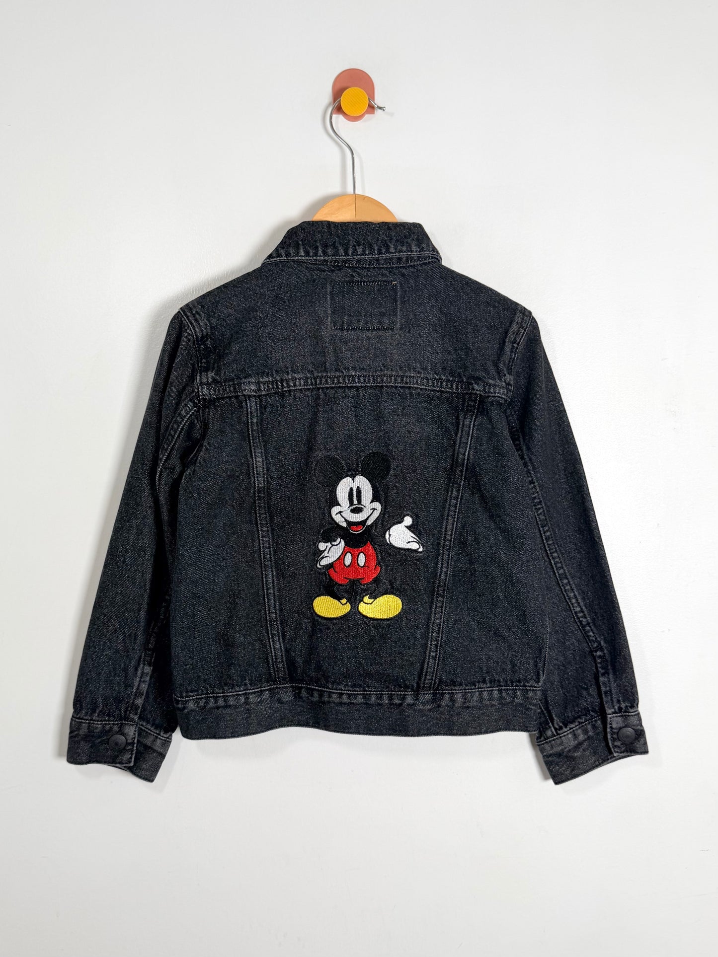 Denim jacket with a cartoon character on a white background