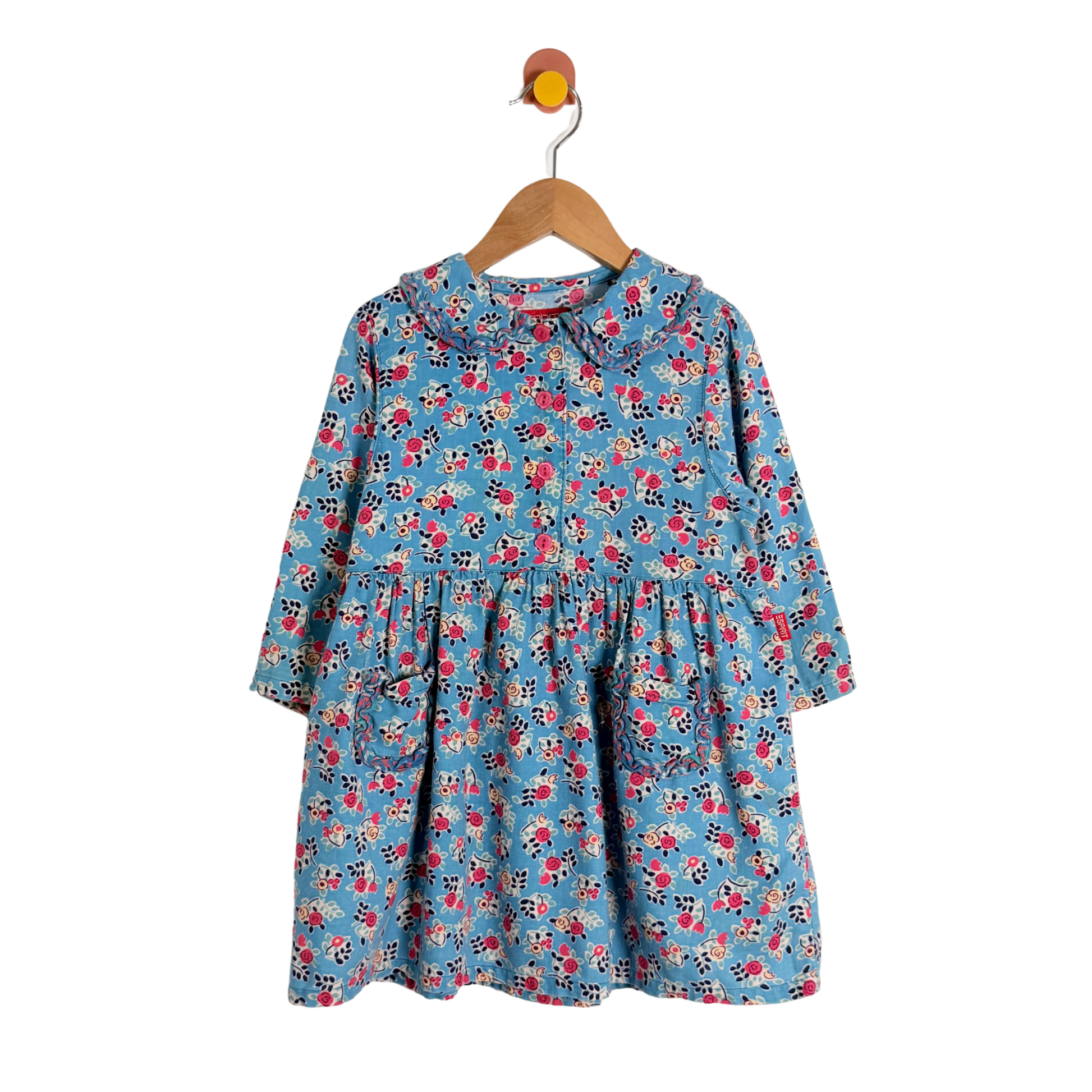 Children's floral dress on a hanger against a white background