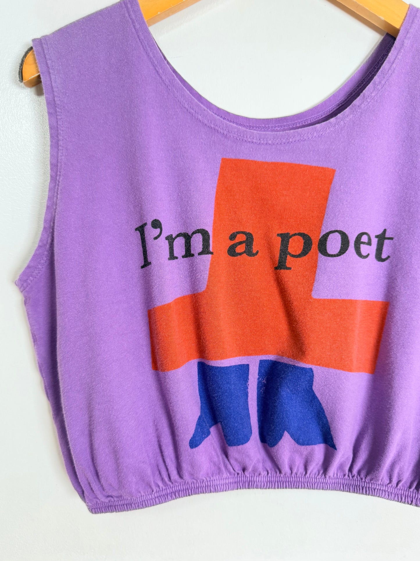 Purple tank top with 'I'm a poet' text and blue boots graphic on a white background