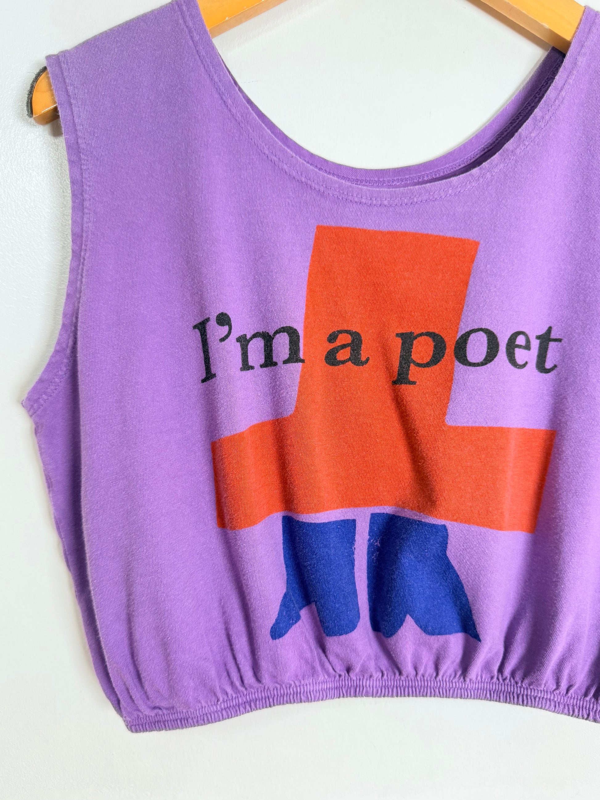 Purple tank top with 'I'm a poet' text and blue boots graphic on a white background