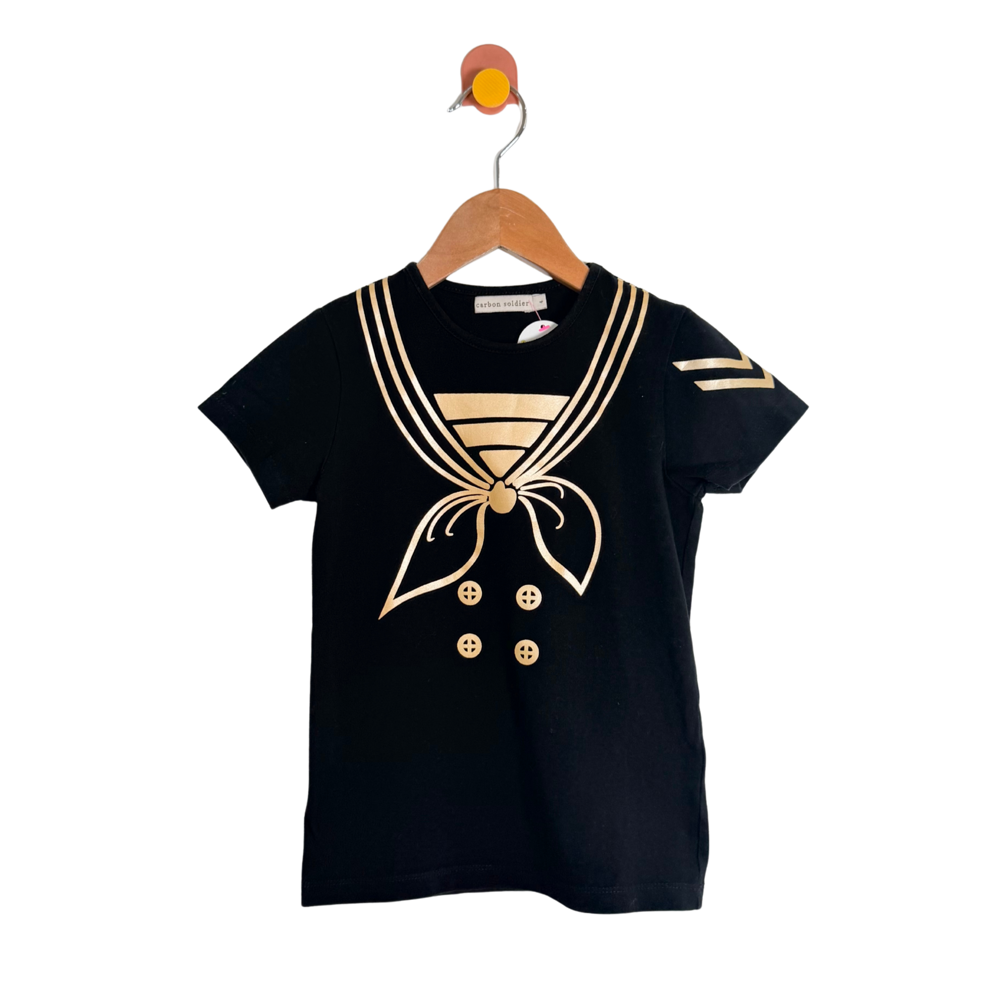 Black t-shirt with gold accents on a wooden hanger against a white background