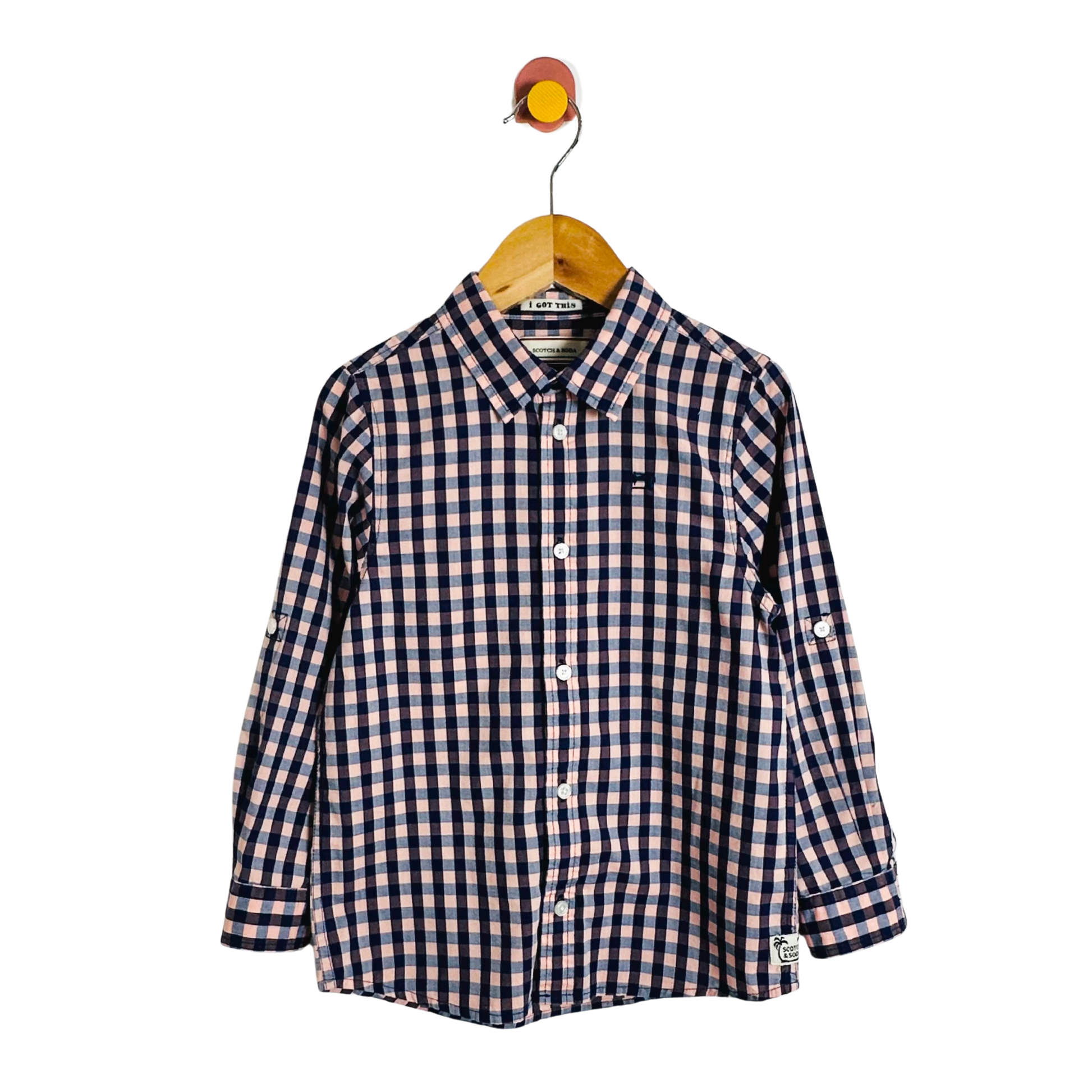 Checkered shirt on a hanger against a white background