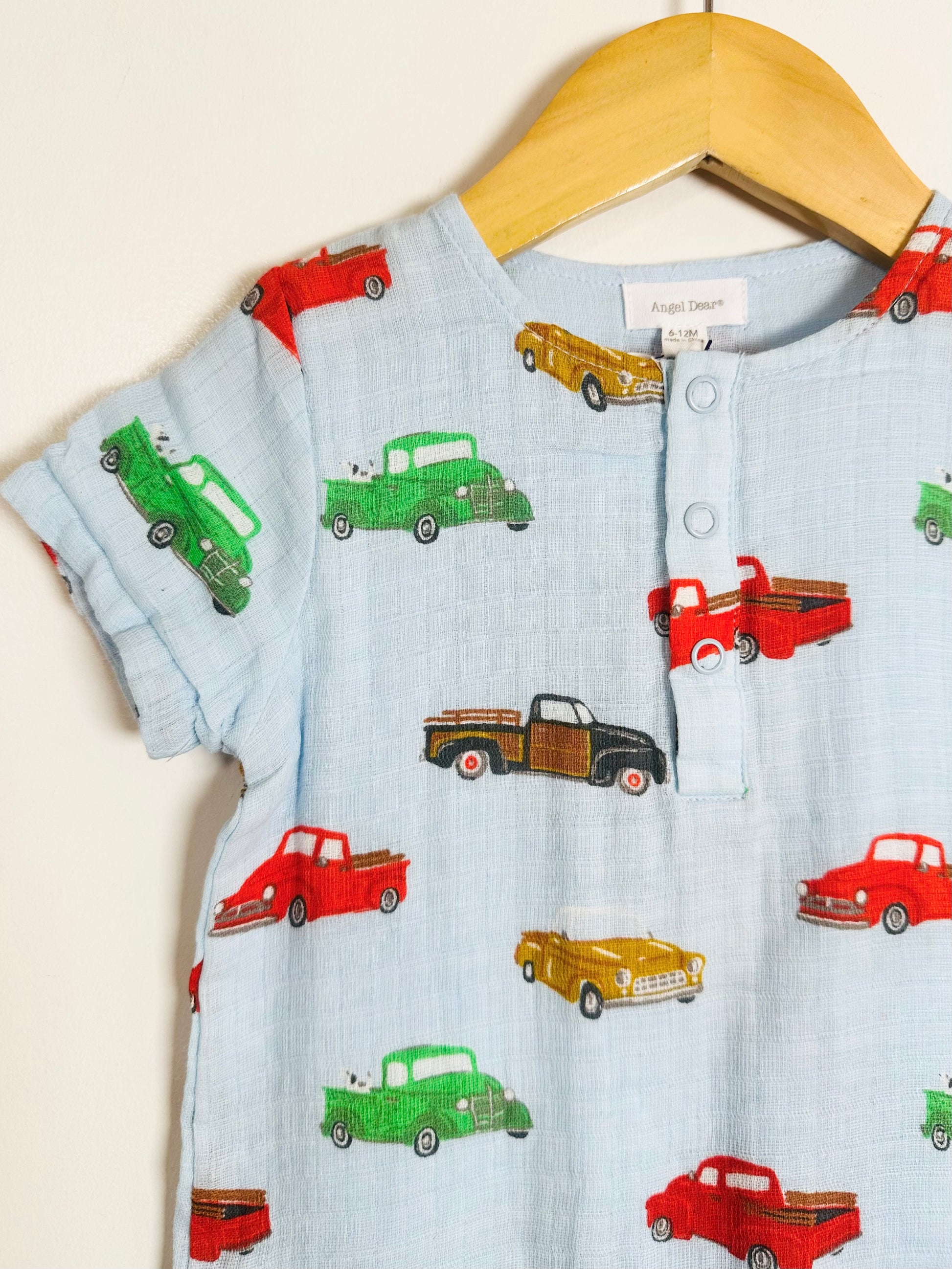 Children's shirt with vintage truck pattern on a hanger