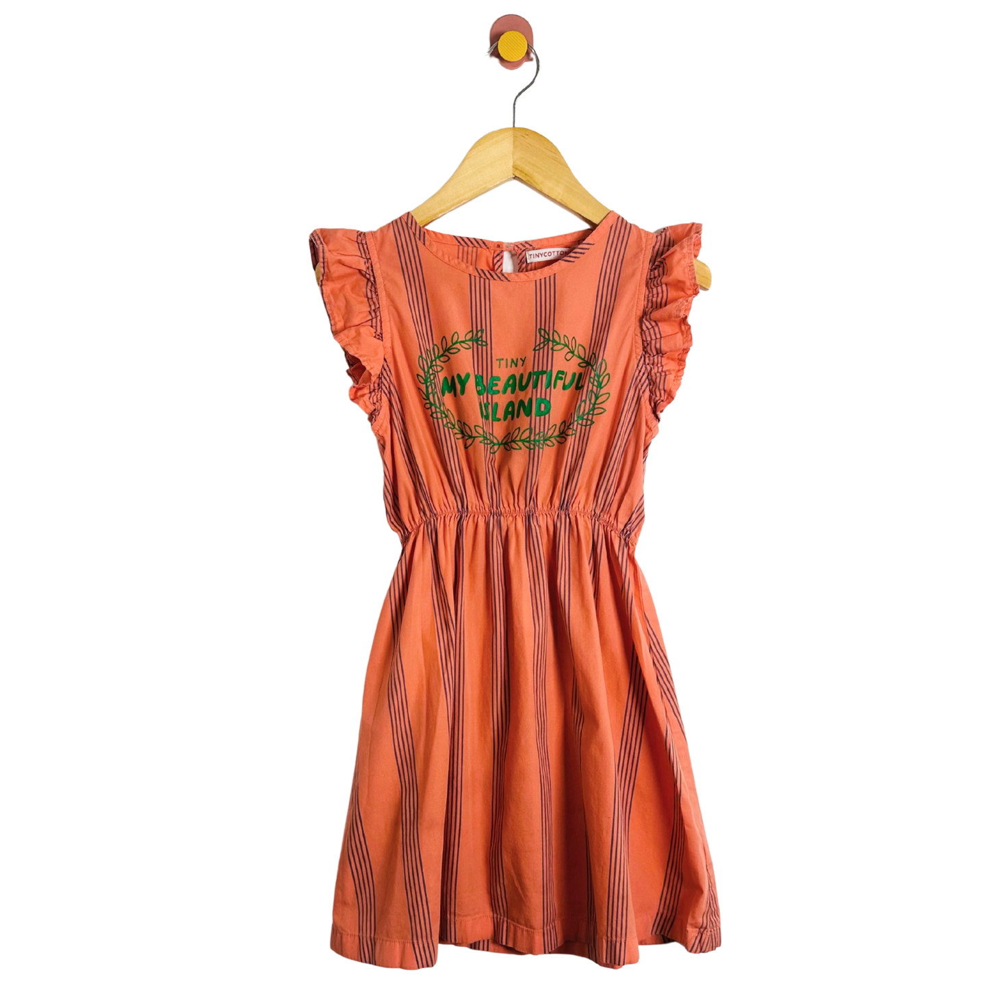 Orange dress with text and graphics on a hanger against a white background