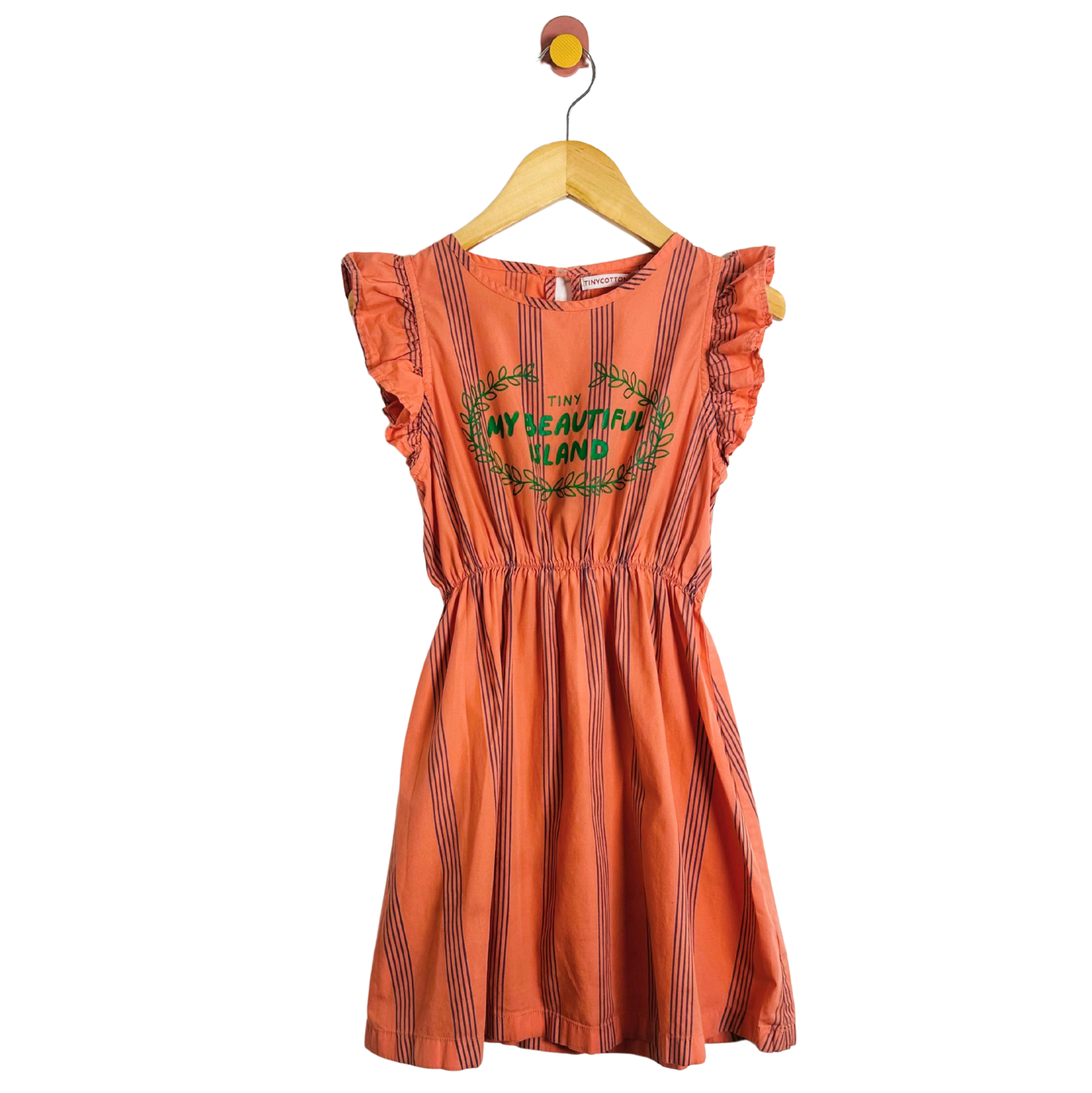 Orange dress with text and graphics on a hanger against a white background