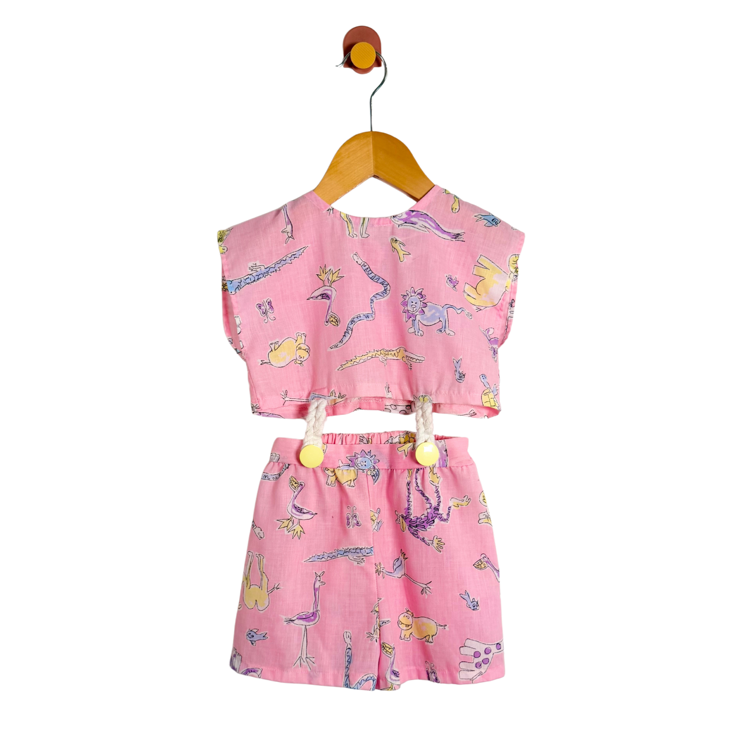 Pink children's outfit with cartoon designs on a white background