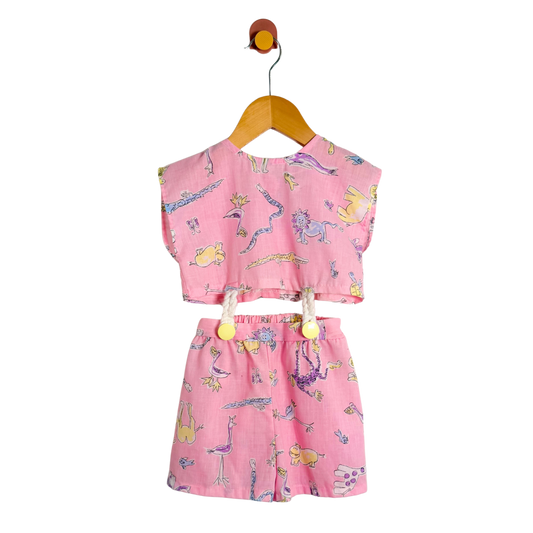 Pink children's outfit with cartoon designs on a white background