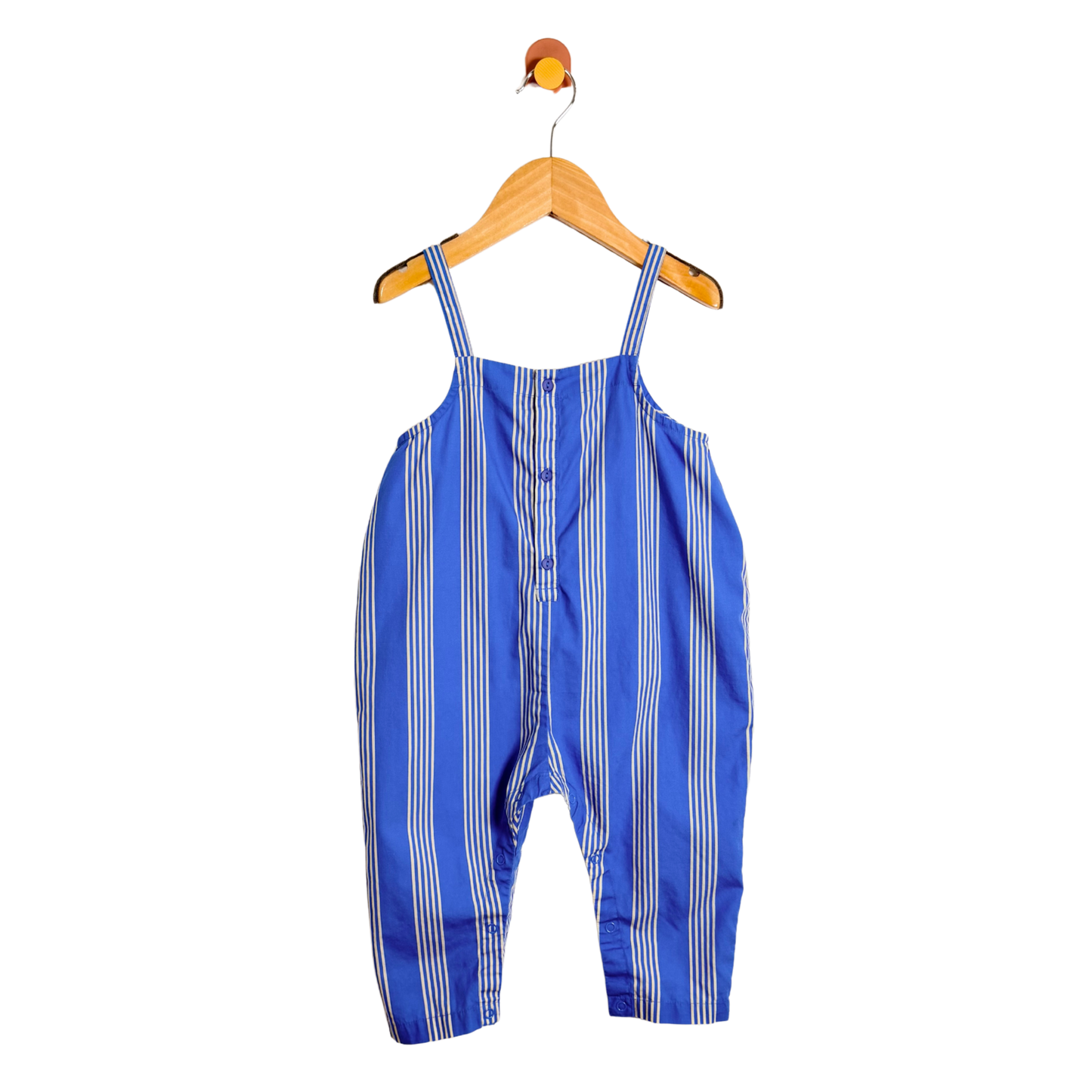 Blue and white striped overalls on a wooden hanger against a white background