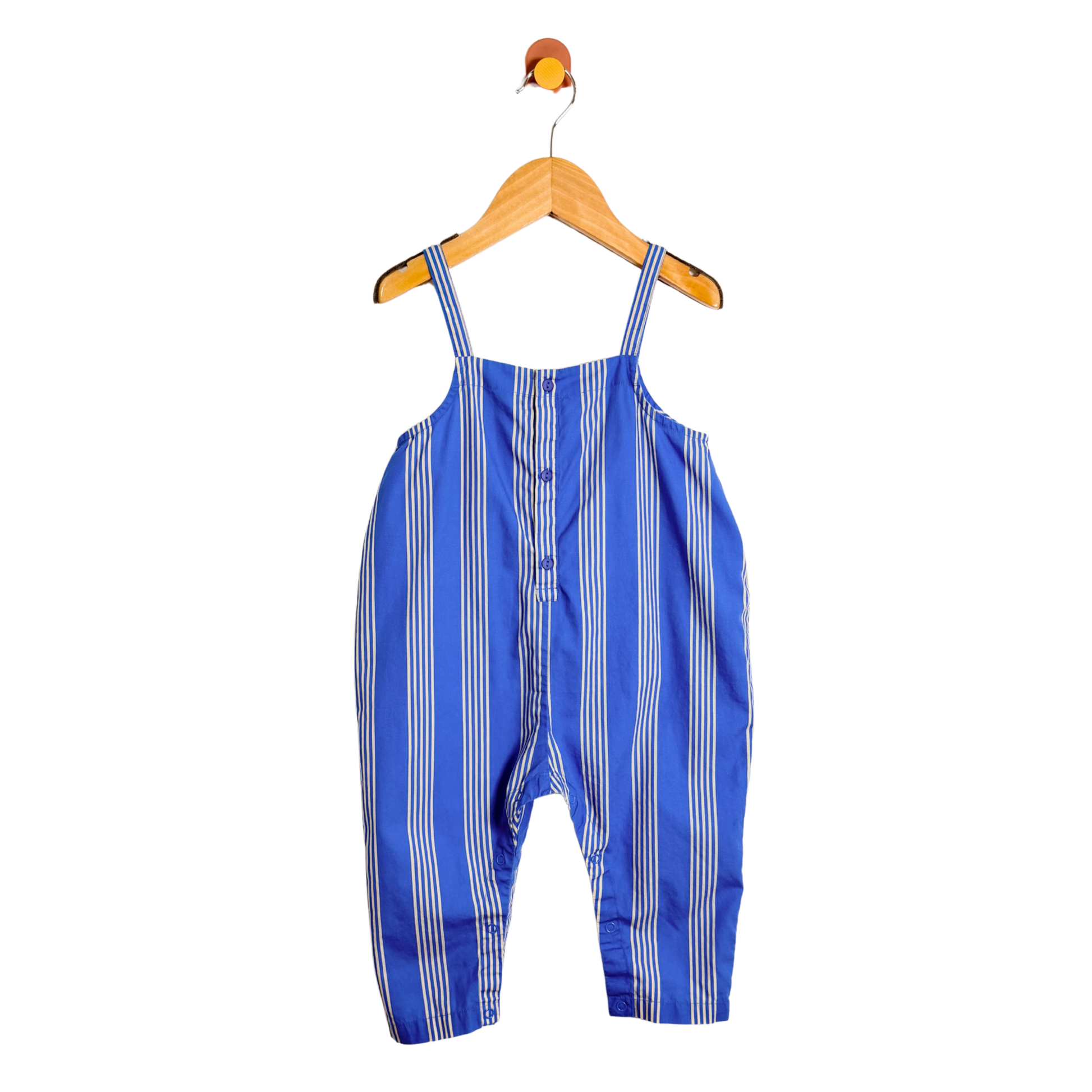 Blue and white striped overalls on a wooden hanger against a white background