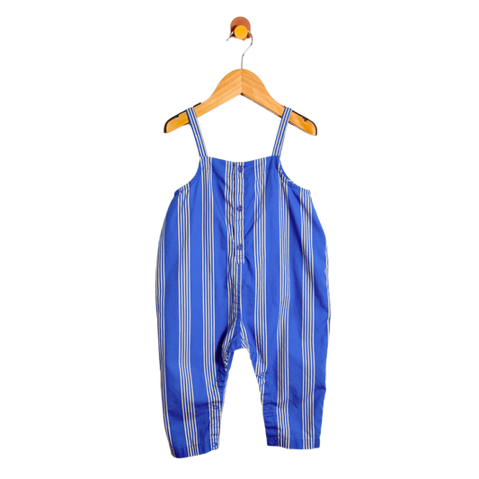 Blue and white striped overalls on a wooden hanger against a white background