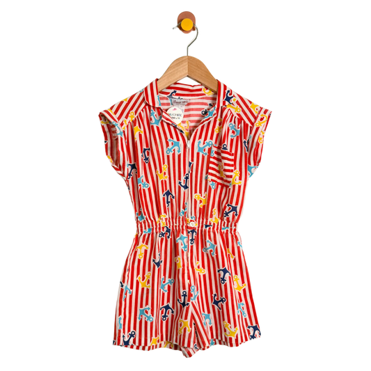 Red and white striped romper with anchor pattern on a hanger against a white background