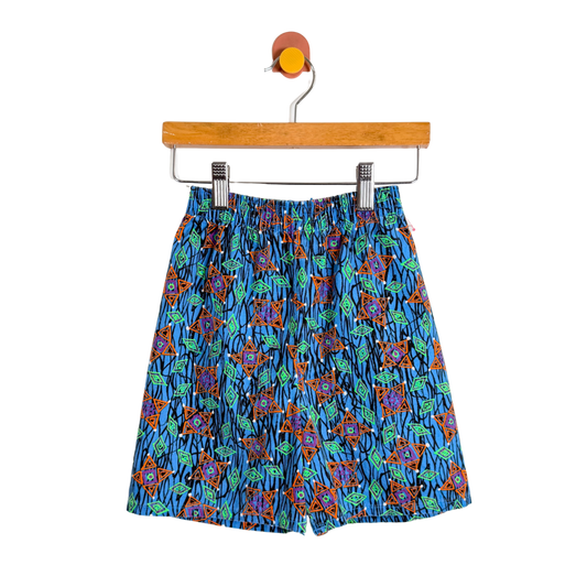 Colorful patterned shorts on a hanger against a white background