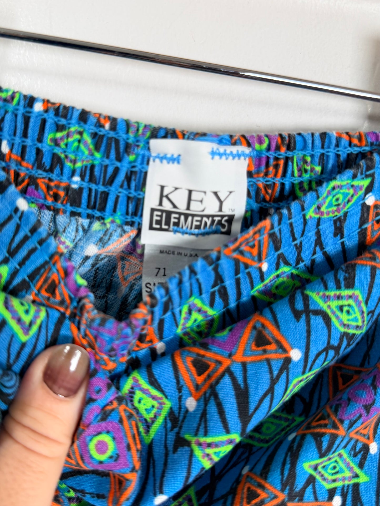 Colorful fabric with geometric patterns and a 'Key Elements' label.