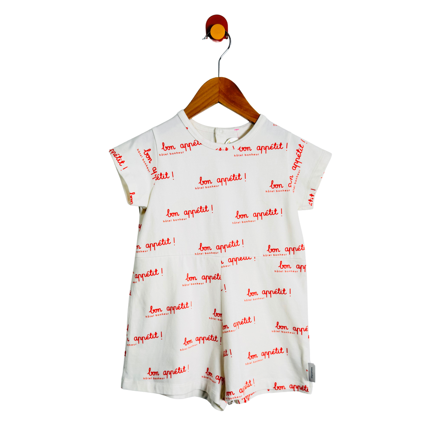 White dress with red text on a hanger against a white background