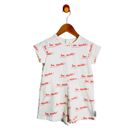 White dress with red text on a hanger against a white background