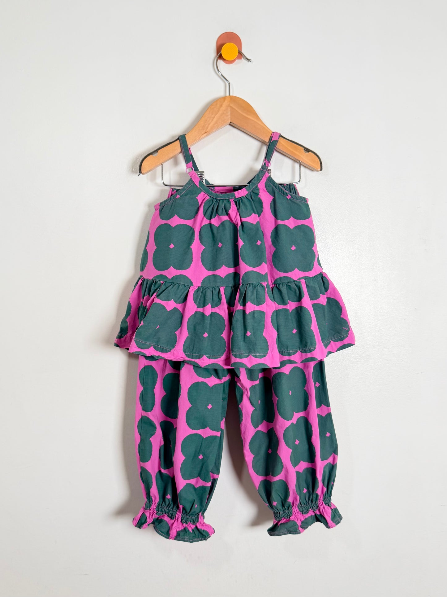 Children's outfit with pink floral pattern on a white background