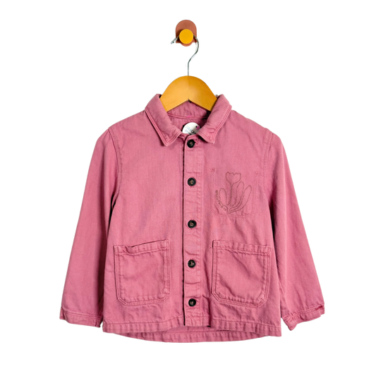 Pink jacket with a floral design on a hanger against a white background