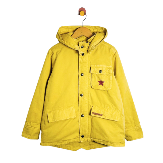 Yellow jacket with a star patch on a white background