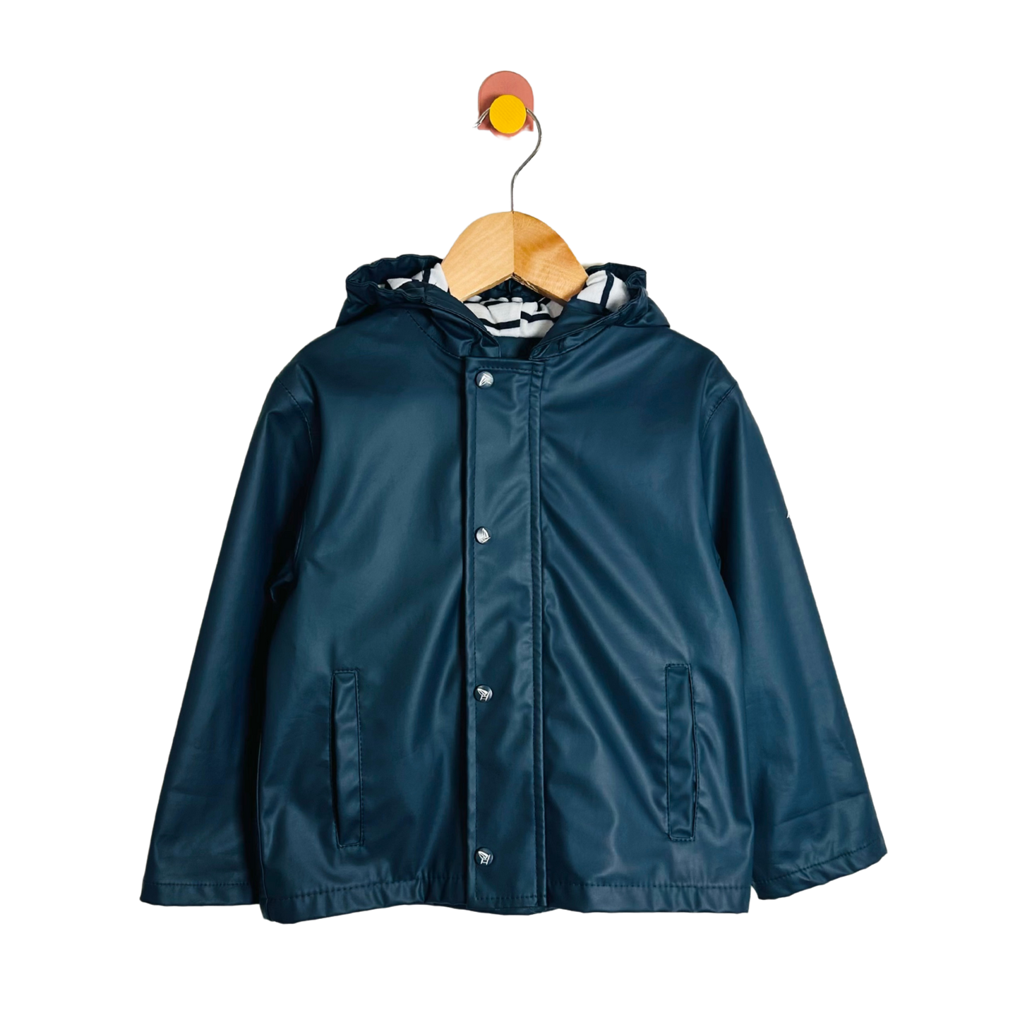 Blue raincoat on a wooden hanger against a white background