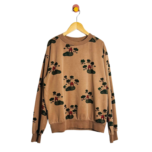Beige sweater with black and green pattern on a hanger against a white background