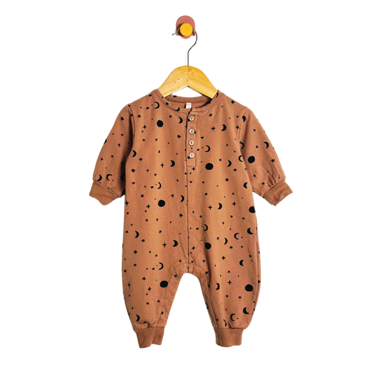 Brown baby onesie with star pattern on a hanger against a white background