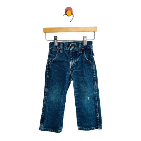 Blue jeans on a wooden hanger against a white background