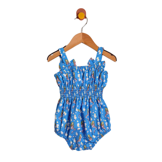 Blue children's romper with cartoon print on a wooden hanger against a white background