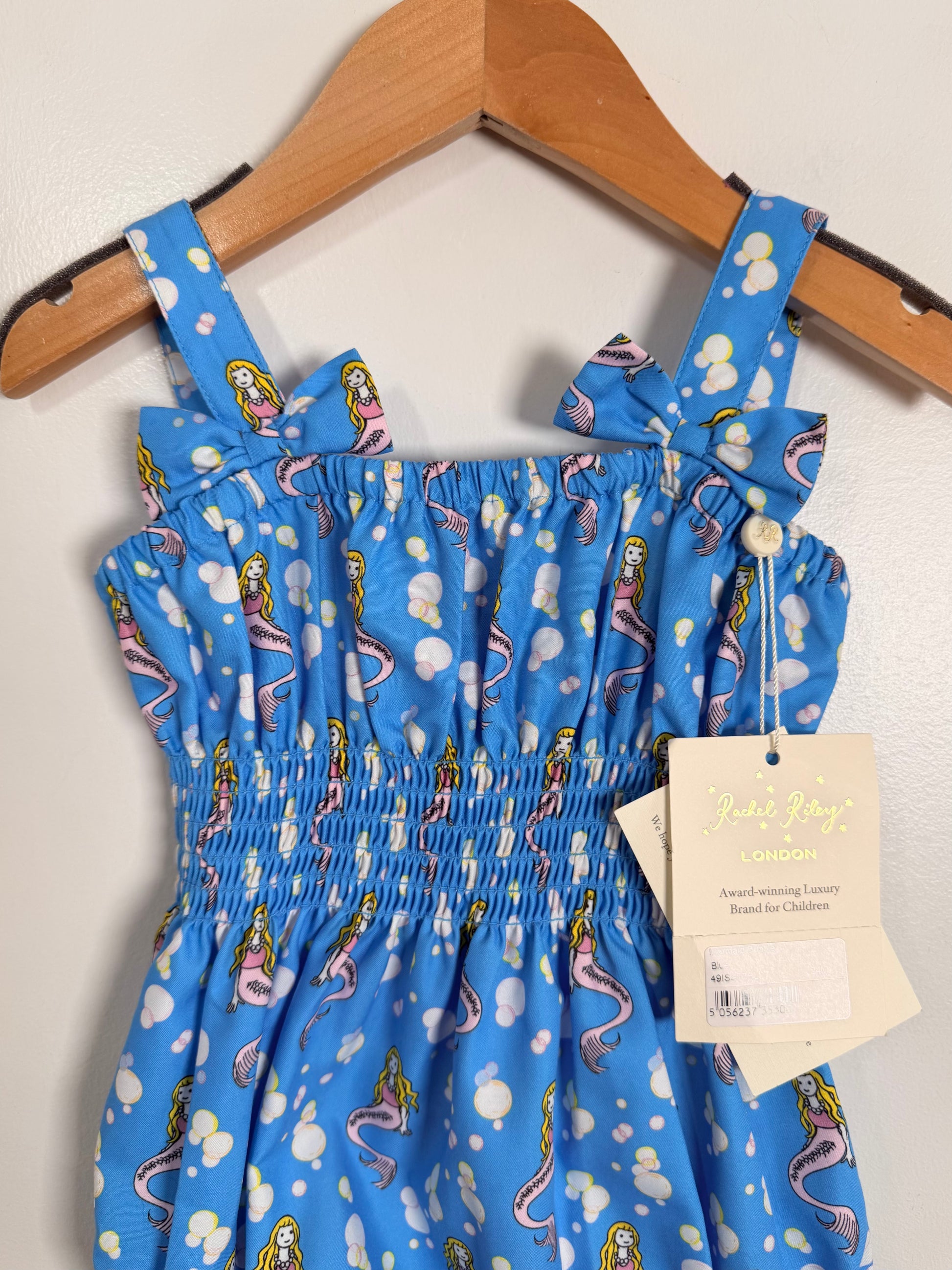 Blue dress with mermaid pattern on a hanger