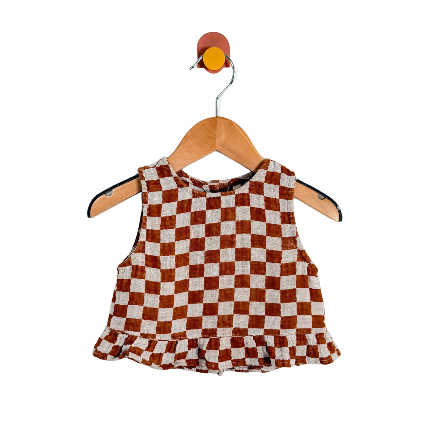 Checkered top on a wooden hanger with a white background