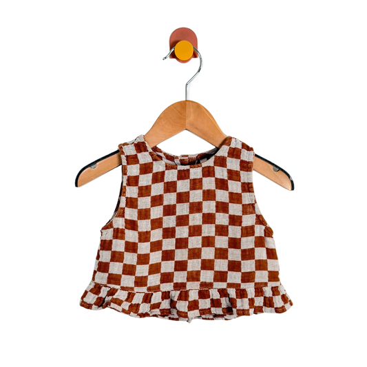 Checkered top on a wooden hanger with a white background