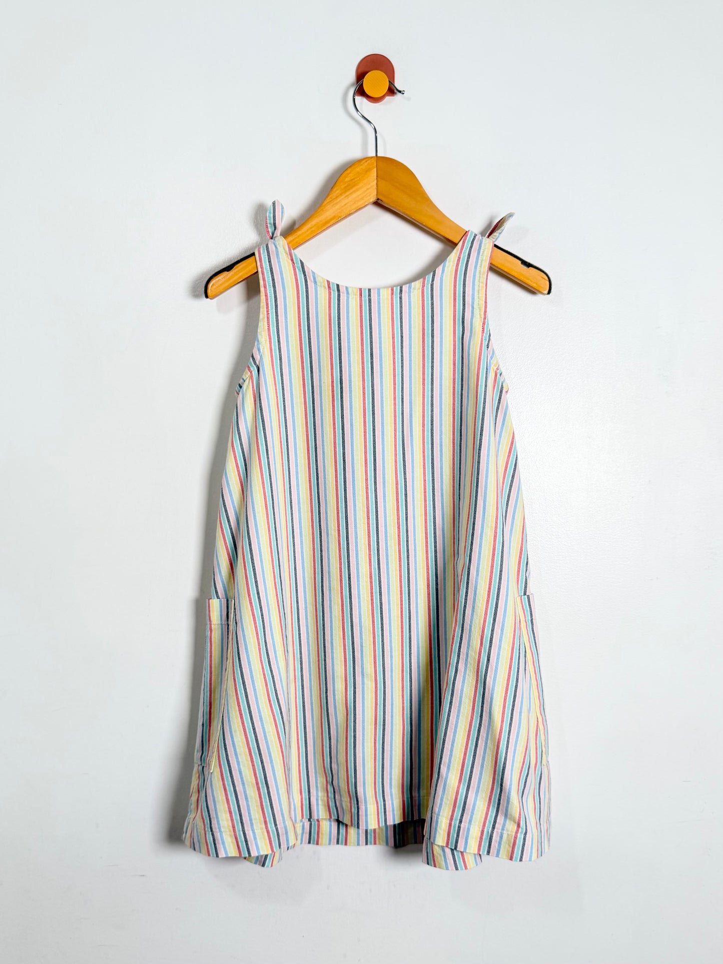 Striped dress on a hanger against a white background