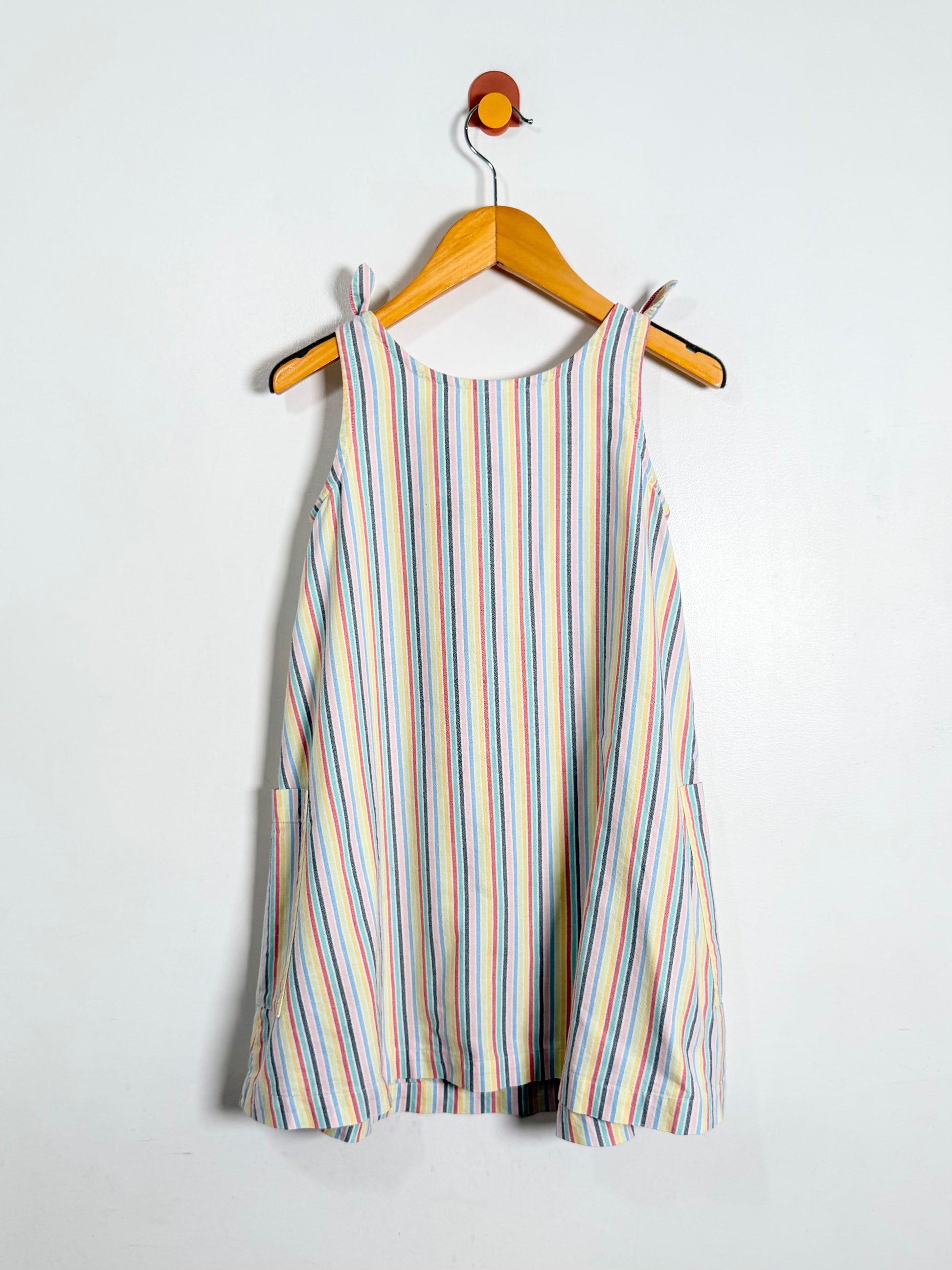 Striped dress on a hanger against a white background