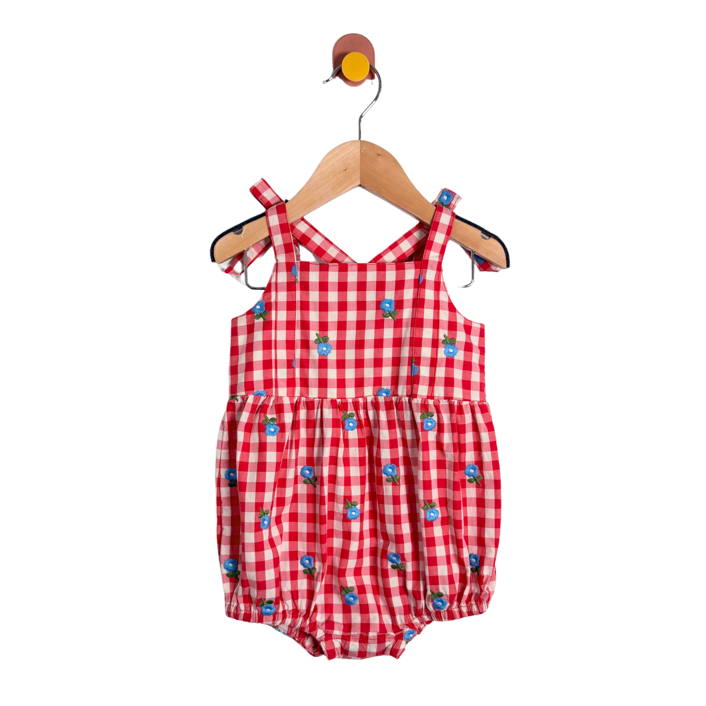 Red checkered baby romper with blue accents on a hanger against a white background