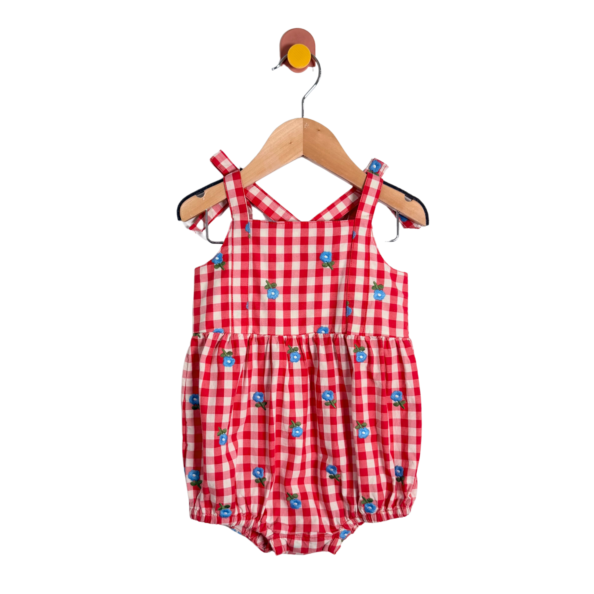 Red checkered baby romper with blue accents on a hanger against a white background