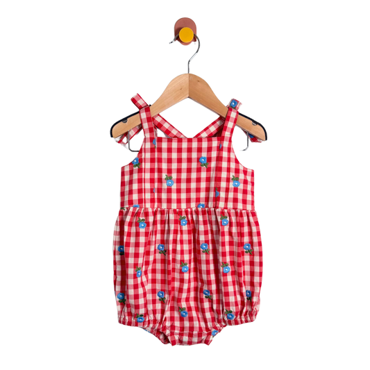 Red checkered baby romper with blue accents on a hanger against a white background