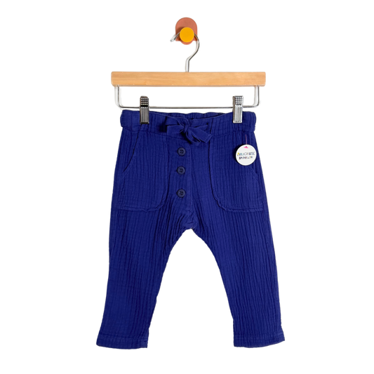 Blue ribbed baby pants on a hanger with a white background
