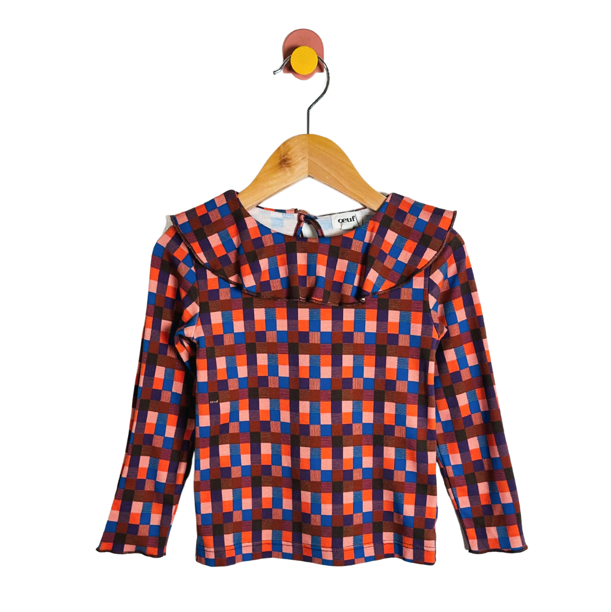 Plaid shirt on a wooden hanger against a white background