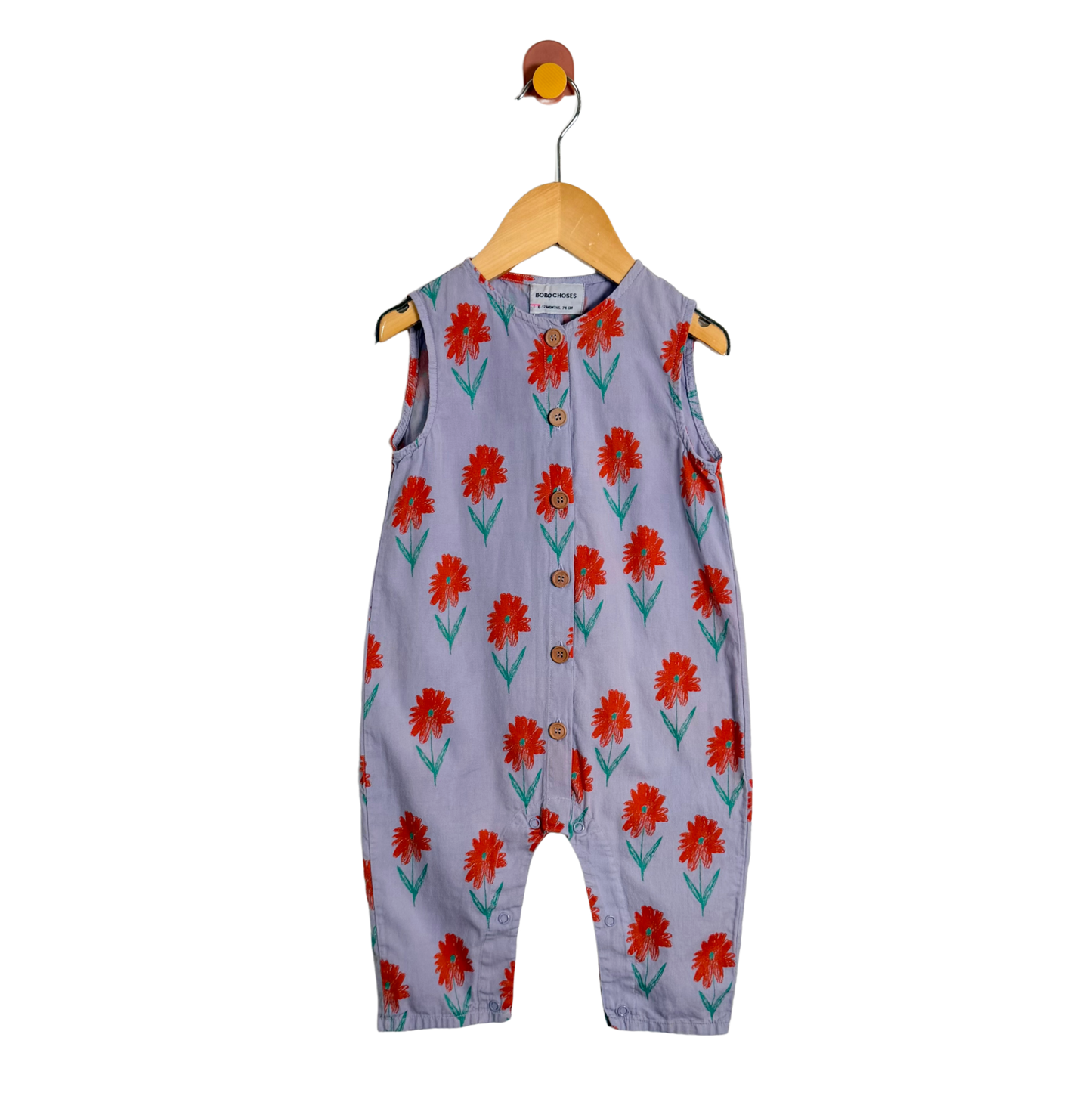 Children's sleeveless jumpsuit with red floral pattern on a white background